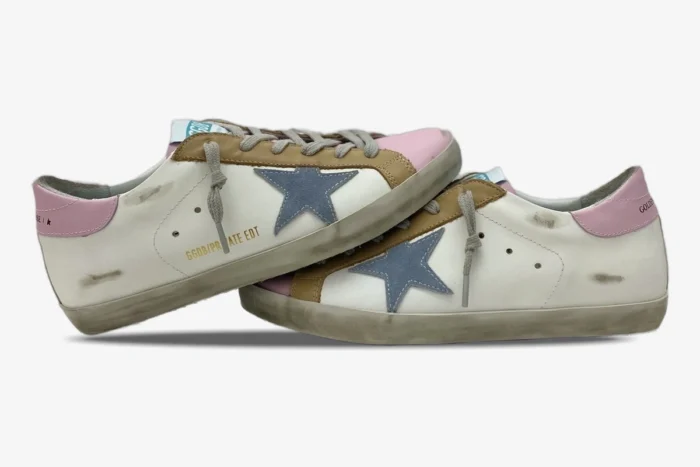 Side view of Golden Goose Super-Star sneakers in white with pink, brown, and a blue star.