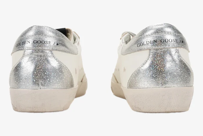 Rear view of Golden Goose Super-Star sneakers featuring silver glitter and metallic heel tabs. - SKU GWF00101.F000312.10272