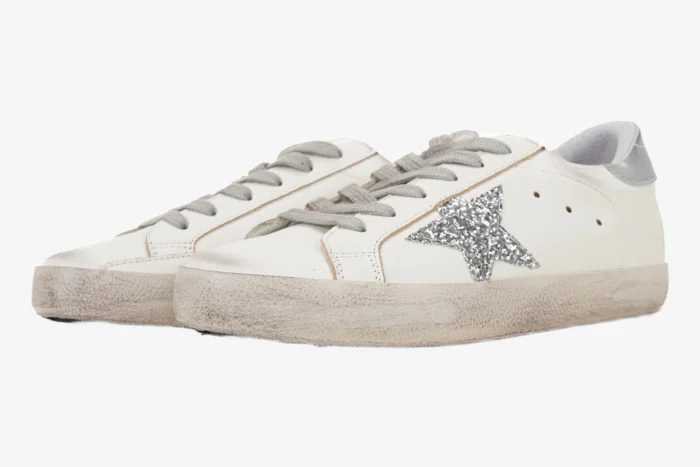 White Golden Goose Super-Star sneakers with silver glitter star and distressed soles, side view. - SKU GWF00101.F000312.80185
