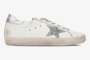 White Golden Goose Super-Star sneaker with a silver glitter star and distressed sole, side view. - SKU GWF00101.F000312.80185