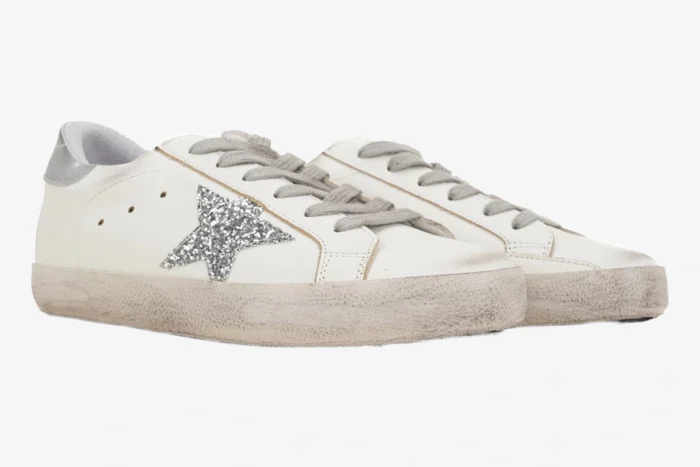 Golden Goose Super-Star white sneakers with silver glitter star and distressed soles, side view. - SKU GWF00101.F000312.80185