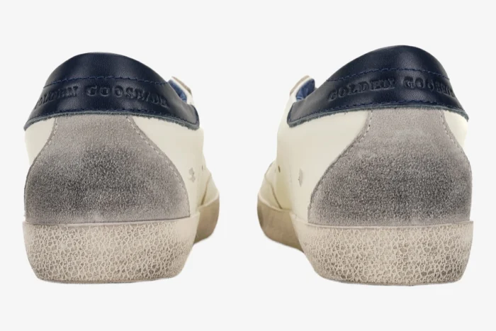 Rear view of Golden Goose Super-Star sneakers with blue heel tabs and grey suede details. - SKU GMF00101.F000312.10273
