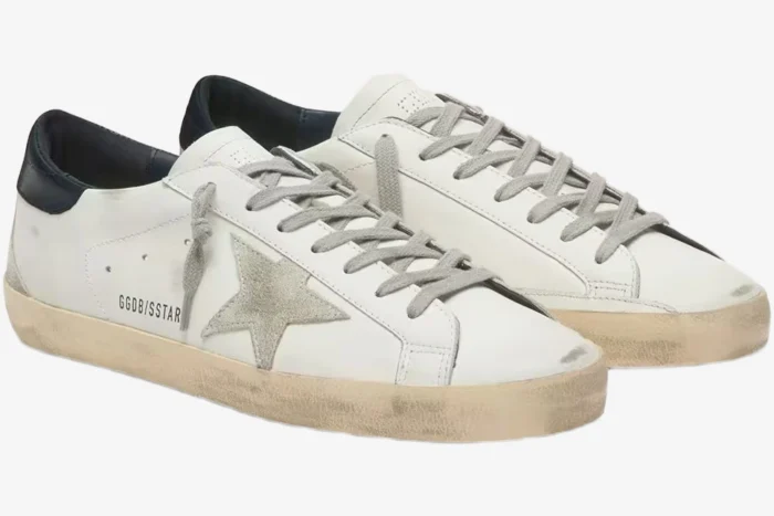 Golden Goose Super-Star white leather sneakers with suede star and blue heel tab, three-quarter side view. - SKU GMF00101.F000312.10273