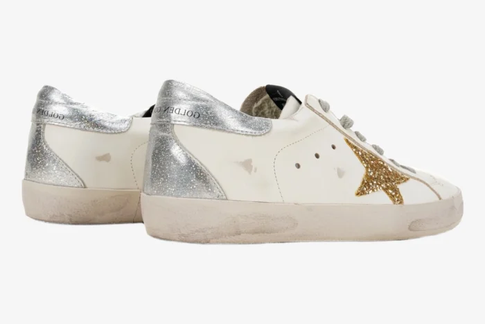 Golden Goose Super-Star sneakers in white with gold glitter star and silver heel tab, side-rear view. - SKU GWF00101.F000312.10272