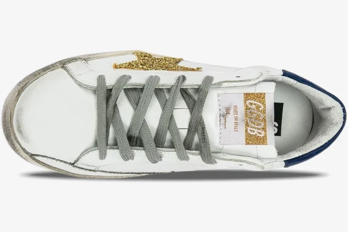 Top-down view of Golden Goose Super-Star white leather sneaker with gold glitter star and grey laces. - SKU GWF00101.F000321.10271