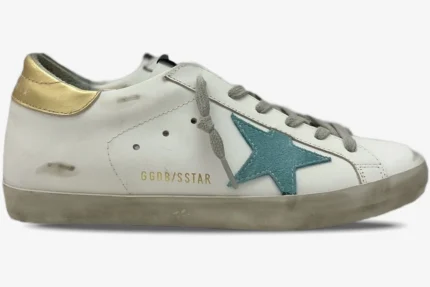 Side view of Golden Goose Super-Star white leather sneaker with a teal star and gold heel tab. - SKU GWF00101.F000312.10273