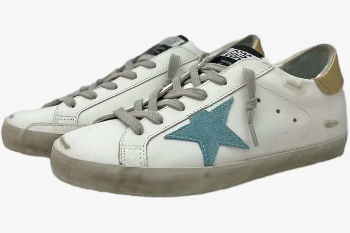 Golden Goose Super-Star white leather sneakers with teal star and gold heel, three-quarter side view. - SKU GWF00101.F000312.10273