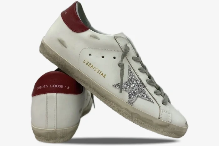Golden Goose Super-Star white sneakers with silver glitter star and red heel tab, side and heel view. - SKU GWF00101.F000312.10272