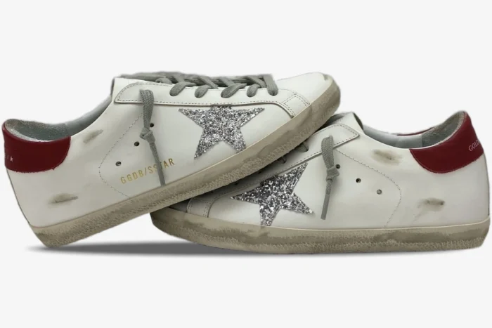 Golden Goose Super-Star white leather sneakers with silver glitter star and red heel, side view. - SKU GWF00101.F000312.10272