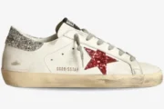 Side view of a Golden Goose Super-Star sneaker in white leather featuring a red glitter star and silver glitter heel. - SKU GWF00101.F000312.10273