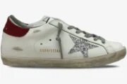 Golden Goose Super-Star white leather sneaker with silver glitter star and red heel tab, side view. - SKU GWF00101.F000312.10272