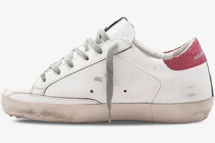 Side profile of a Golden Goose Super-Star sneaker in white leather with rose glitter heel tab. - SKU GWF00101.F000321.10273