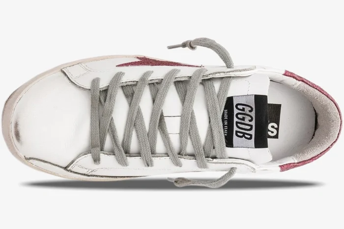 Top-down view of Golden Goose Super-Star white leather sneakers with rose glitter accents and grey laces. - SKU GWF00101.F000321.10273