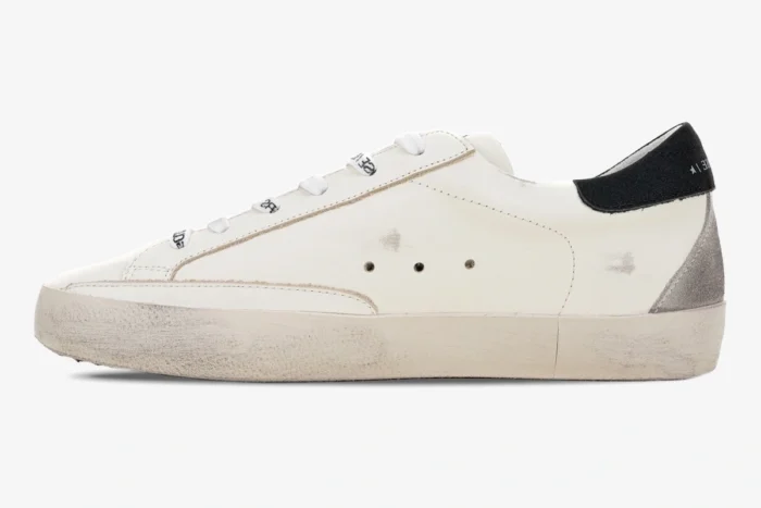 Golden Goose Super-Star white leather sneaker with black and metallic silver accents, side profile view. - SKU GMF00101.F000312.10273