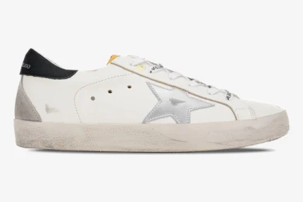 Side profile of Golden Goose Super-Star white leather sneakers with metallic silver star and black heel tab. - SKU GMF00101.F000312.10273