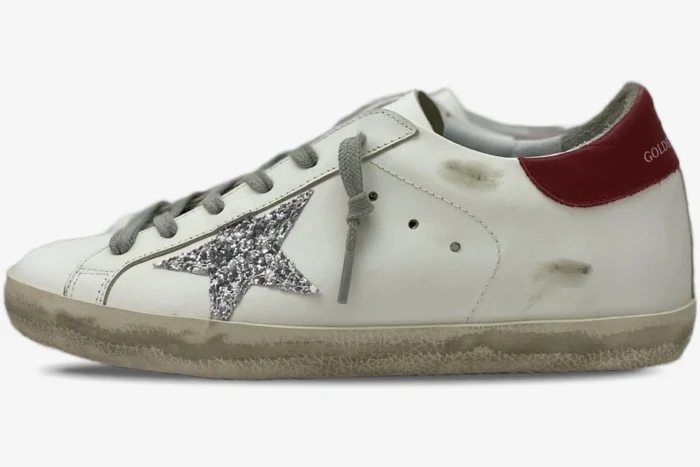 Golden Goose Super-Star white leather sneaker with silver glitter star and red heel tab, side view. - SKU GWF00101.F000312.10272