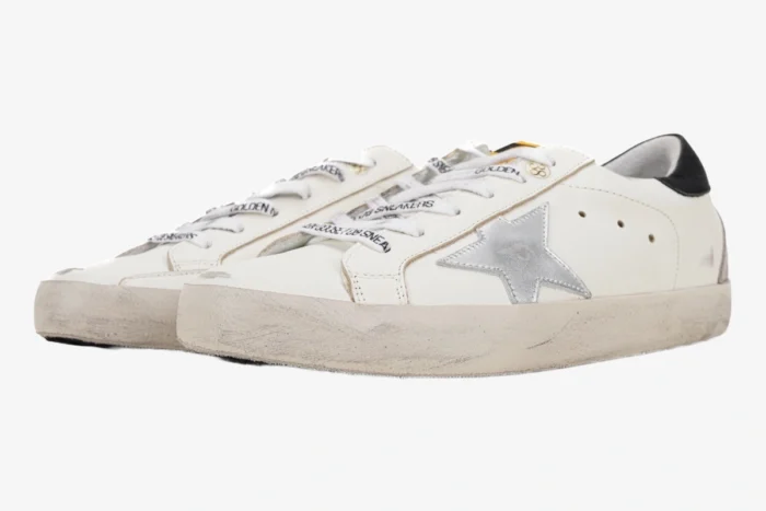 Golden Goose Super-Star white leather sneakers with silver star and black heel, side angle view. - SKU GMF00101.F000312.10273