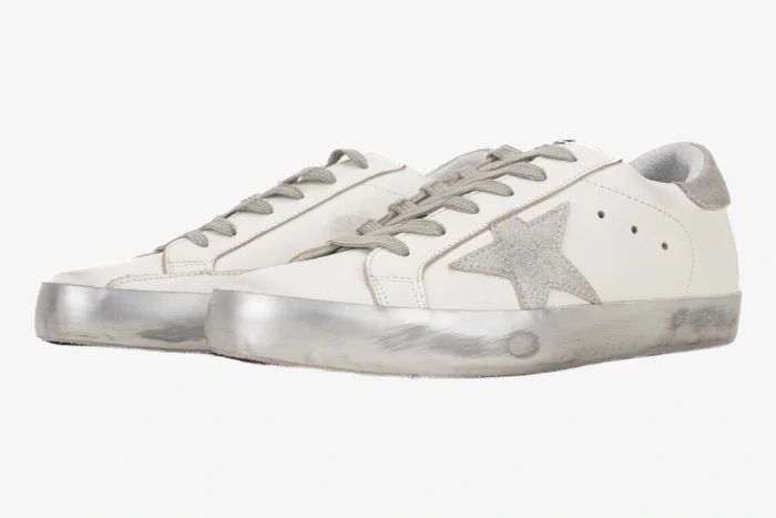Golden Goose White and Silver Super-Star Sneakers shown from a side angle with a distressed finish. - SKU GMF00101.F000312.10273