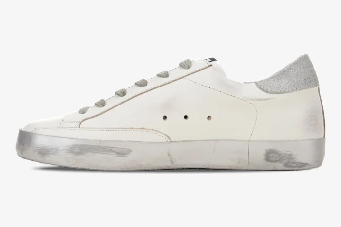 Side view of Golden Goose white and silver Super-Star sneakers with distressed finish. - SKU GMF00101.F000312.10273