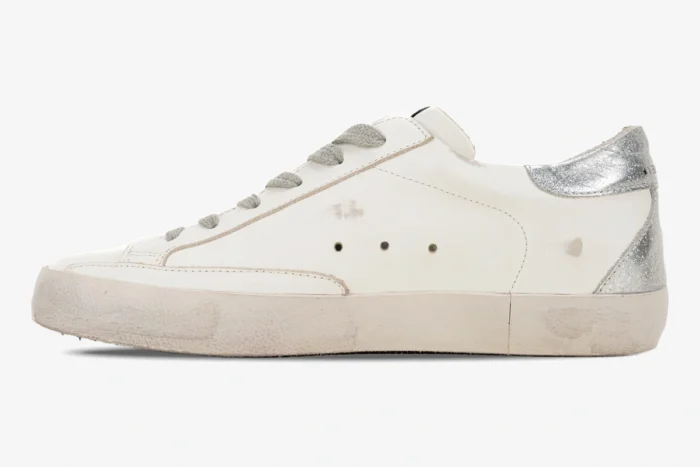 Golden Goose Super-Star white leather sneaker with silver glitter heel, side profile view. - SKU GWF00101.F000312.10272