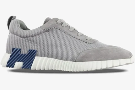 Hermès Bouncing Sneakers in grey mesh and suede with a blue H logo and white ribbed sole, side view. - SKU H202934ZH