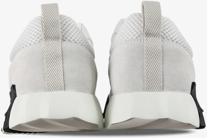 Rear view of Hermes Bouncing Sneakers in white and black featuring mesh uppers and chunky soles. - SKU H202934ZH