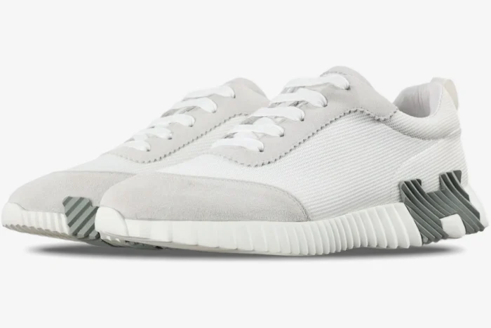 Hermes Bouncing Sneakers in white grey mesh, side view showing ribbed soles and suede overlays. - SKU H202934ZH02