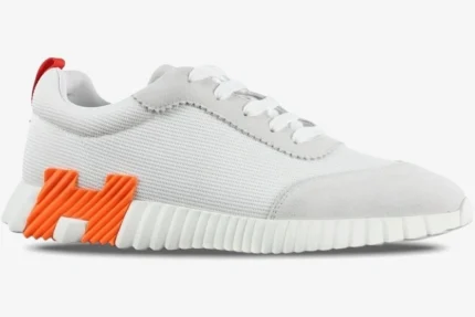 Hermes Bouncing Sneaker in white and orange mesh, side profile view on a white background. - SKU H202934ZH