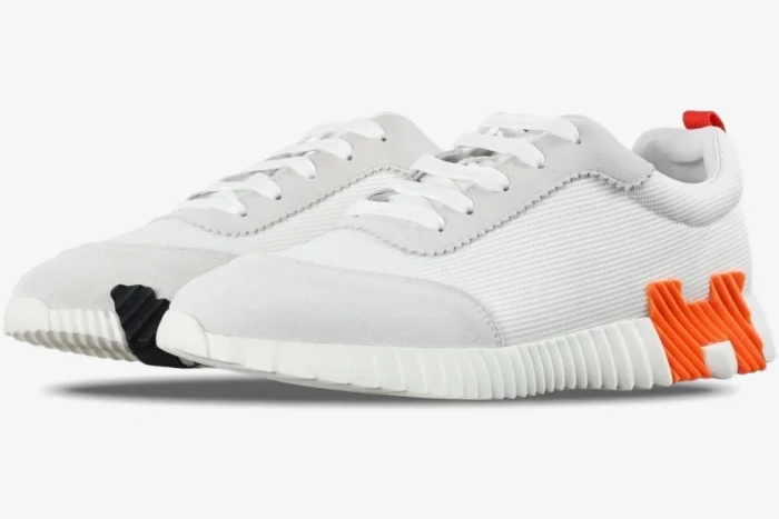Hermes Bouncing Sneakers in white mesh and suede with orange H logo, side profile view. - SKU H202934ZH