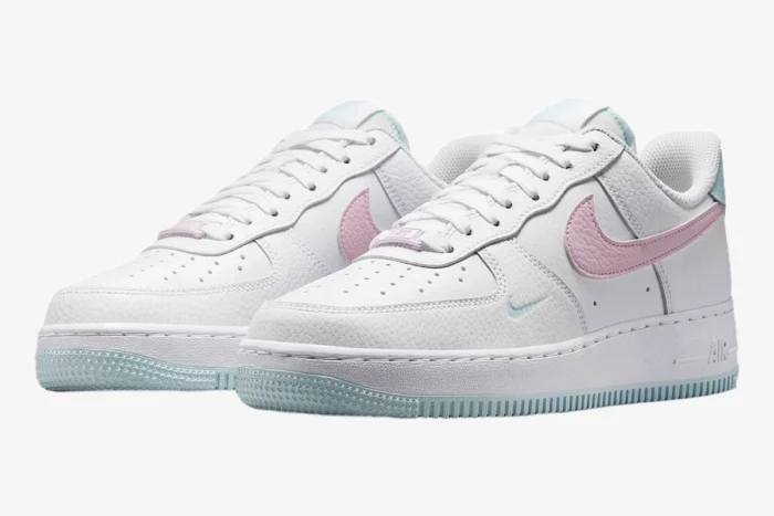 White Nike Air Force 1 '07 Cotton Candy sneakers with pink swooshes and light blue outsoles, three-quarter view. - SKU DD8959-100