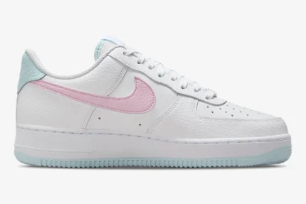 Side view of Nike Air Force 1 '07 Cotton Candy sneakers in white with pink swoosh and light blue accents. - SKU DD8959-100