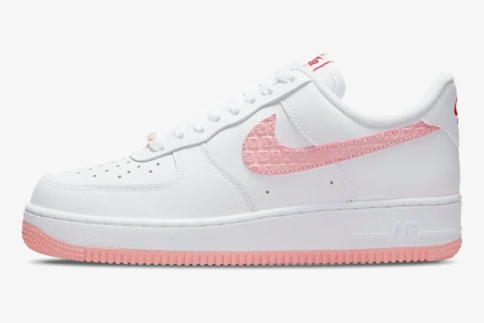 Side profile of a white Nike Air Force 1 '07 Valentine's Day sneaker with a pink embossed Swoosh and pink outsole. - SKU DQ9320-100