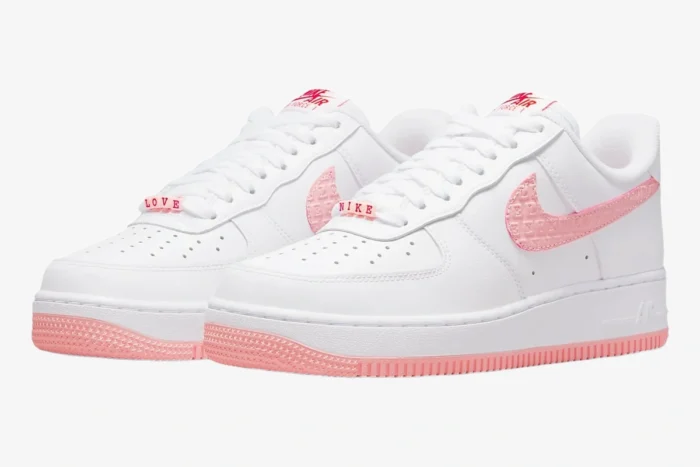 White Nike Air Force 1 '07 Valentine's Day sneakers with pink accents and beads, three-quarter view. - SKU DQ9320-100