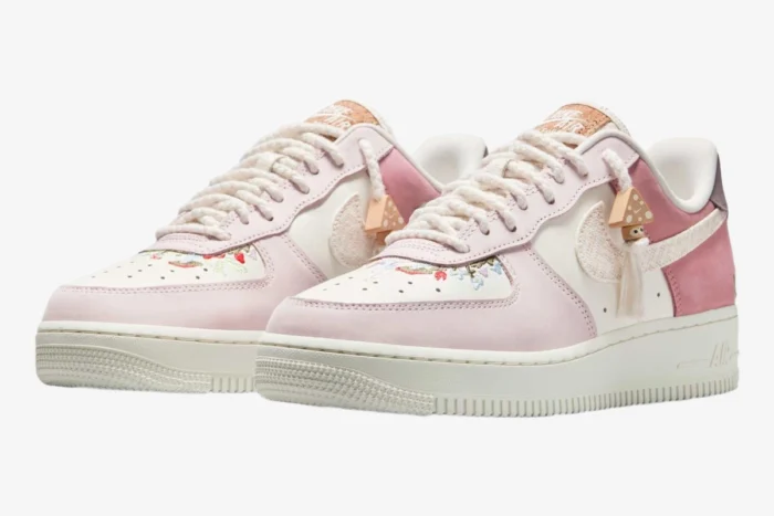 Three-quarter front view of Nike Air Force 1 Low '07 LX Sail Pearl Pink sneakers with floral embroidery.