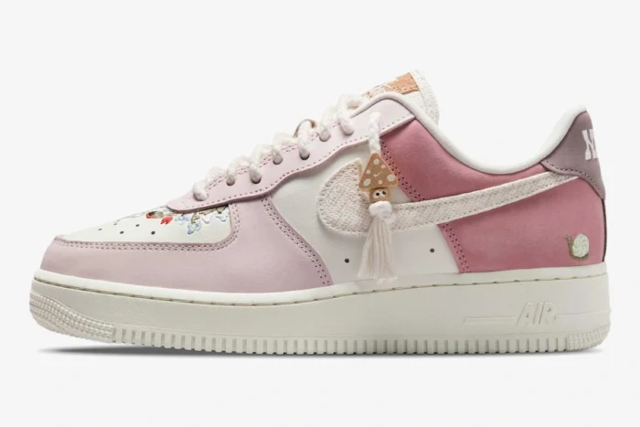 Side profile of Nike Air Force 1 Low '07 LX in Sail Pearl Pink with floral embroidery and mushroom charm.