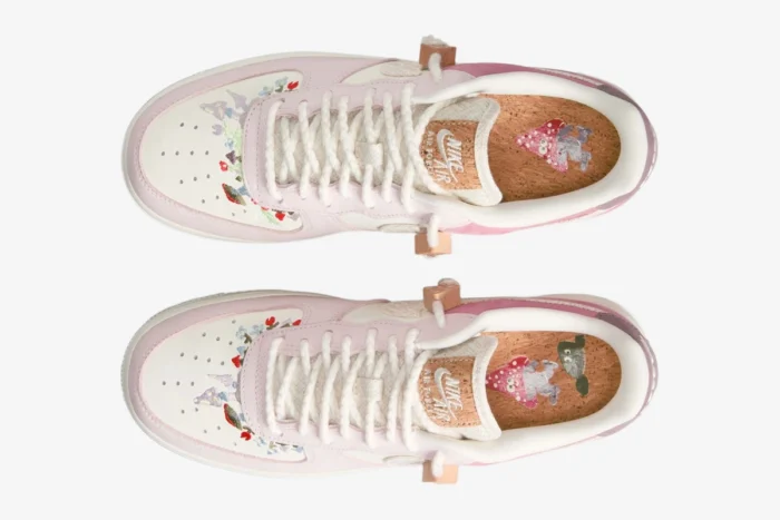Top-down view of Nike Air Force 1 Low '07 LX Sail Pearl Pink sneakers with floral embroidery and cork insoles.
