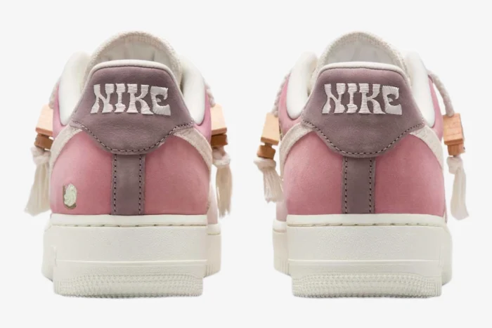 Rear view of Nike Air Force 1 Low '07 LX Sail Pearl Pink sneakers with wavy heel embroidery.