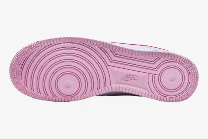 Bottom view of a pink Nike Air Force 1 Low Bubblegum sneaker showing the circular traction outsole pattern. - SKU FJ4146-101