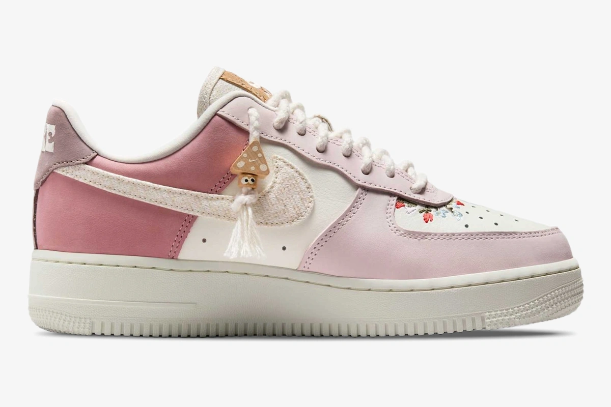 nike-air-force-1-low-sail-pearl-pink-side-647-806 Side profile of Nike Air Force 1 Low '07 LX in Sail Pearl Pink with mushroom charm and floral details.