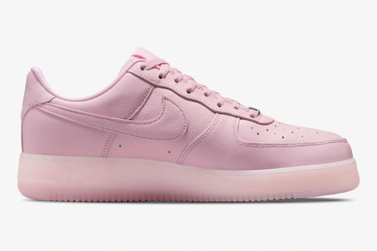 nike-air-force-1-nocta-pink-foam-side-view-cz8065-600-813-535 Side profile of a Nike Air Force 1 x NOCTA sneaker in Pink Foam with a translucent sole. - SKU CZ8065-600