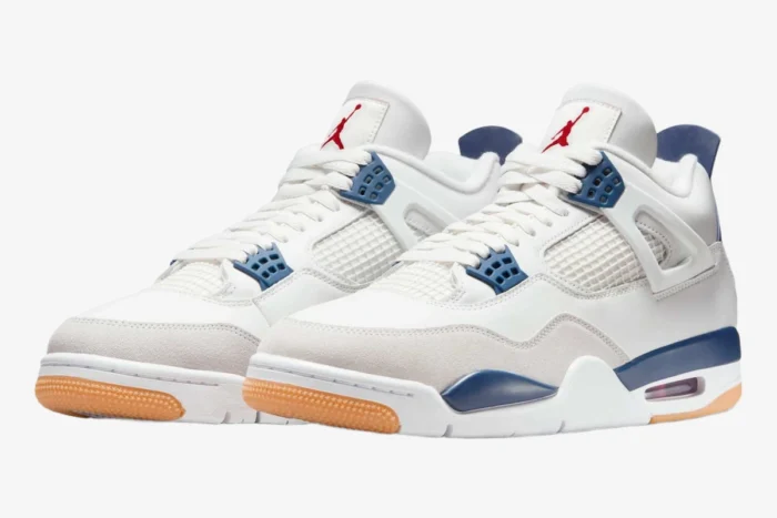 Nike SB Jordan 4 Navy sneakers with white leather and gum soles, three-quarter front view. - SKU DR5415-100