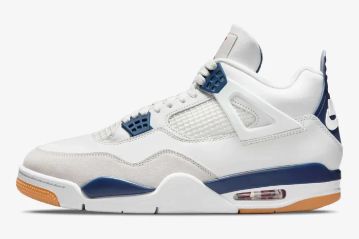Nike SB Air Jordan 4 in navy and white, side profile view showing the gum sole and suede toe cap. - SKU DR5415-100