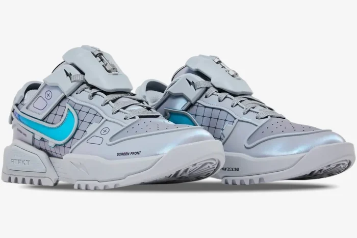 RTFKT x Nike Dunk Genesis 'OG' sneakers in grey and silver with blue accents, three-quarter front view.