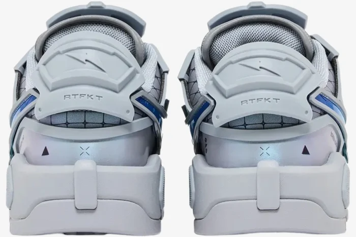 Rear view of grey RTFKT x Nike Dunk Genesis OG sneakers featuring futuristic heel tabs and blue accents.