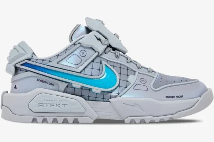 Side profile of grey RTFKT x Nike Dunk Genesis OG sneakers with bright blue swoosh and futuristic panels.